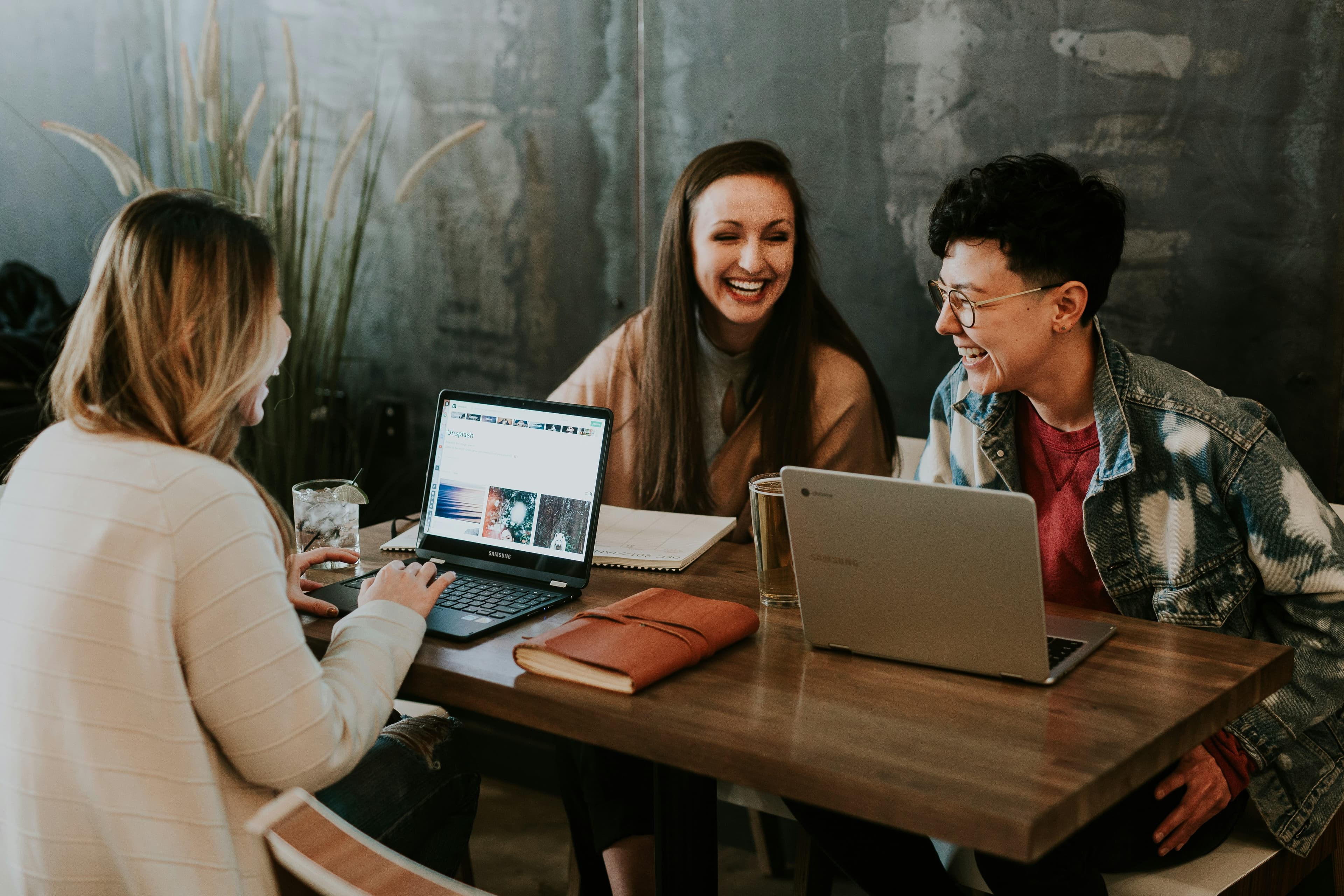 Team members laughing together around a table